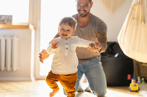 Pai auxilia bebê em seus primeiros passos. - Mustela Brasil - 1